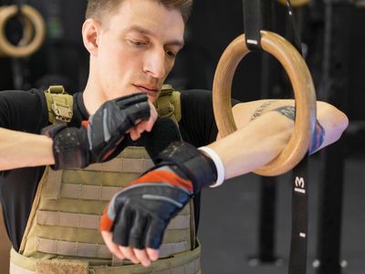 Athletic man adjusting his gloves before a training session