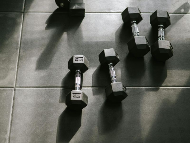 Detailed shot of a chrome dumbbell on a black floor